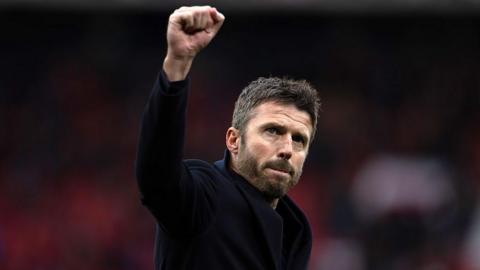 Michael Carrick raises his fist in celebration to Manchester United fans after their win over Manchester City
